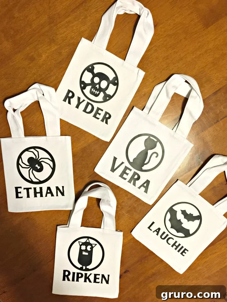 Collection of DIY personalized Halloween canvas treat bags for toddlers, filled with healthy snacks