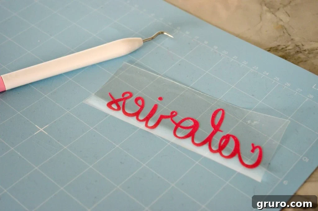 Weeding the Iron-On Vinyl design for your Christmas dish towel