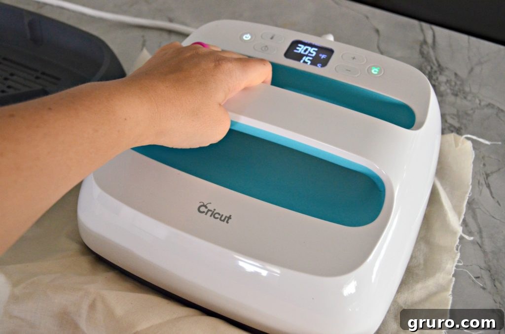 Applying the Iron-On Vinyl with Cricut EasyPress for your DIY Christmas towel