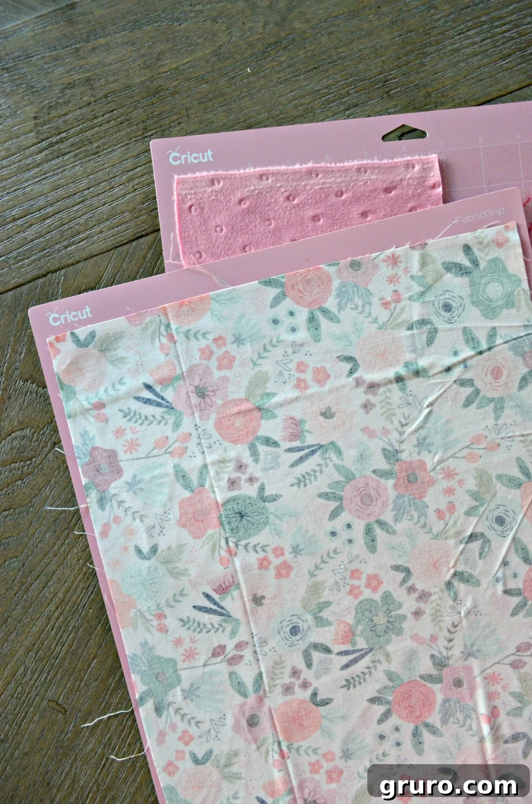 Two pink mats stacked with fabric on it.