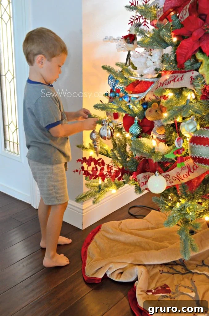 Toddler Joyfully Decorating a Whimsical Christmas Tree with Family