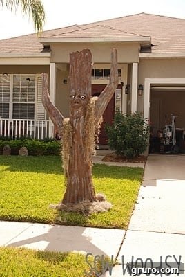 Mr. Woodsy anchoring a spooky tree with a 2x4 in the ground for stability.