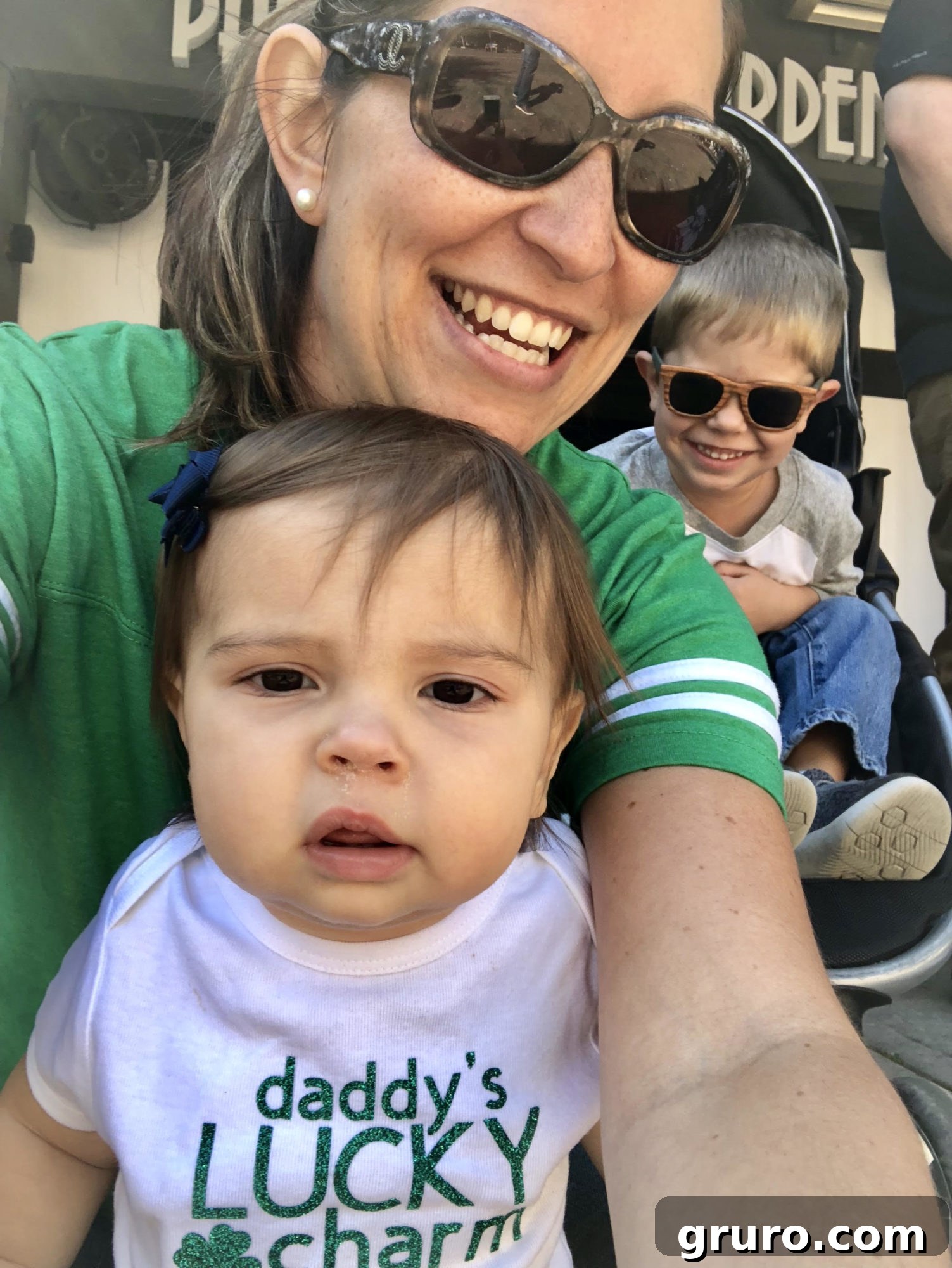 Talisman Tee 14 Child wearing a 'Mommy's/Daddy's Lucky Charm' T-Shirt taking a selfie