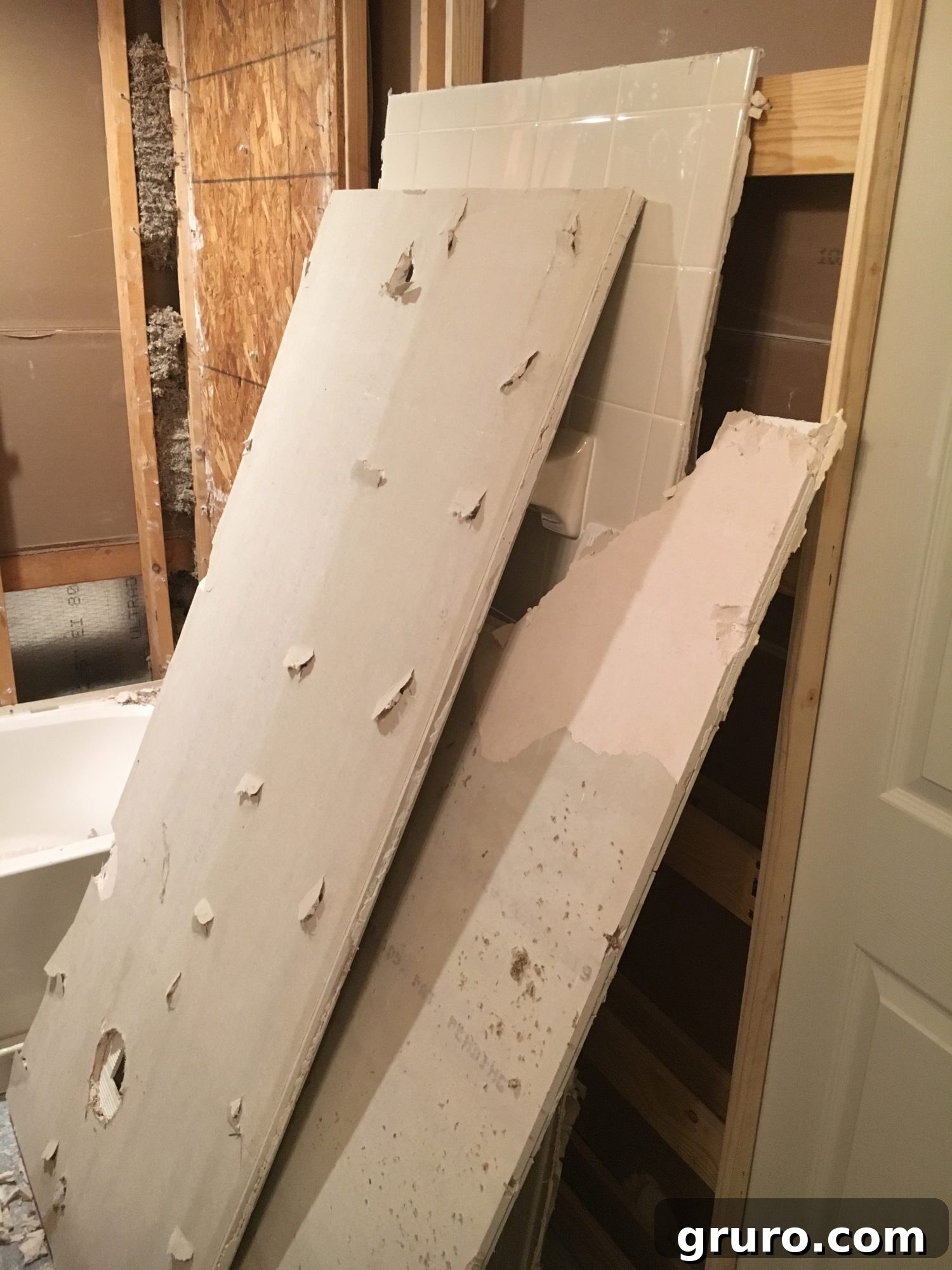 Demolished pieces of tile and hardy board neatly piled