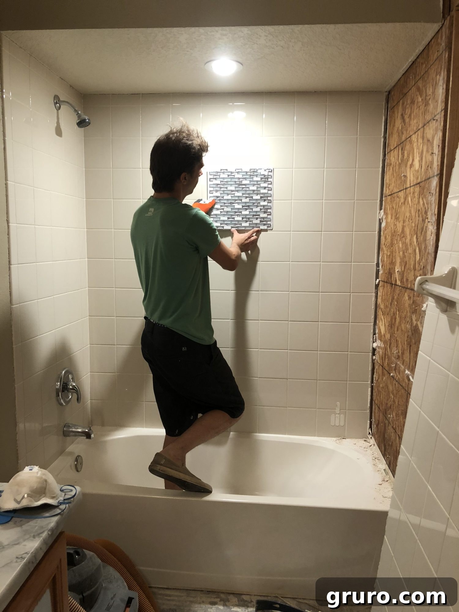Jon holding up Jeffrey Court Alaskan Chill Glass Mosaic tile sample