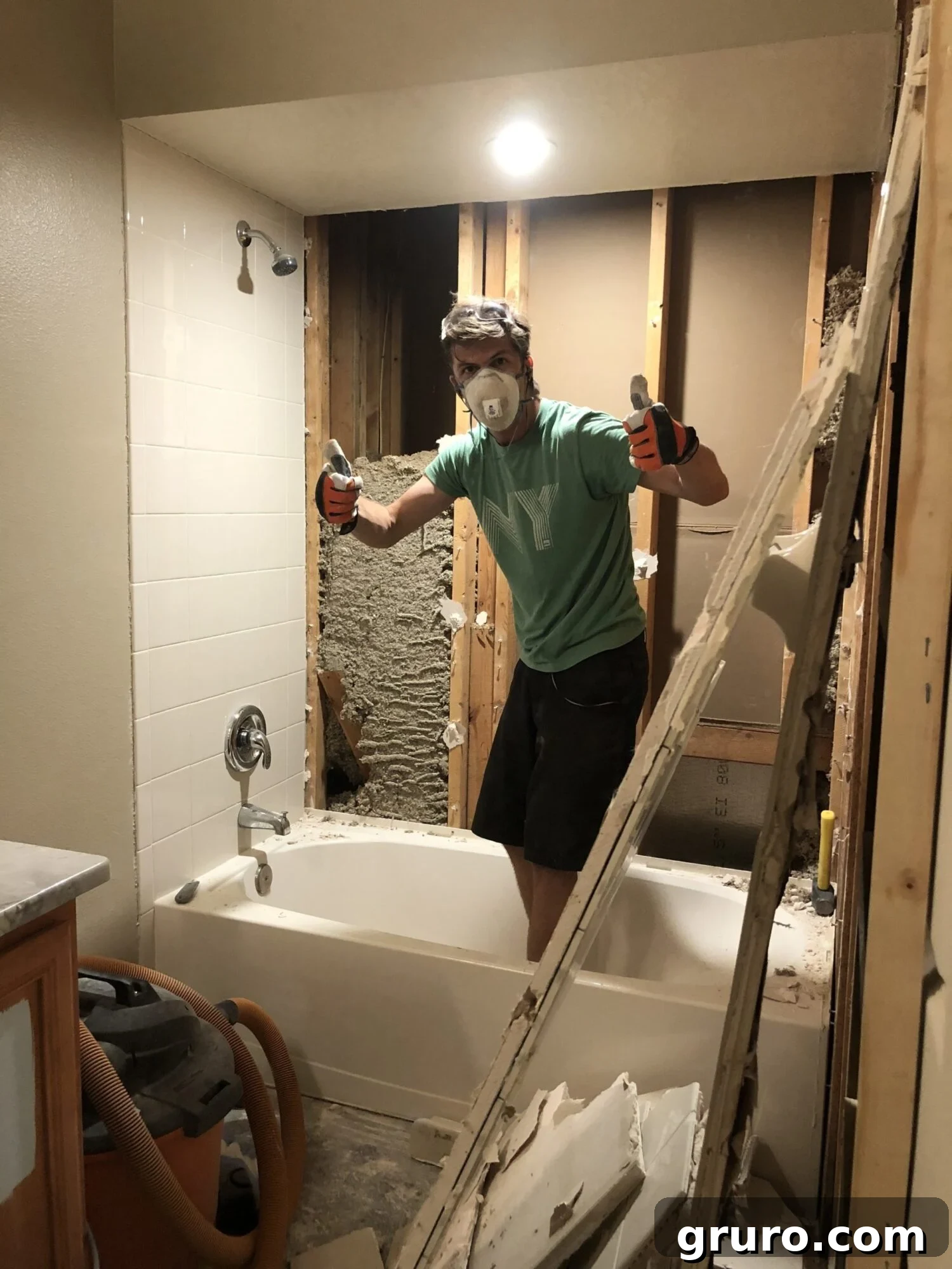 Another wall of the shower cleared, showing exposed studs