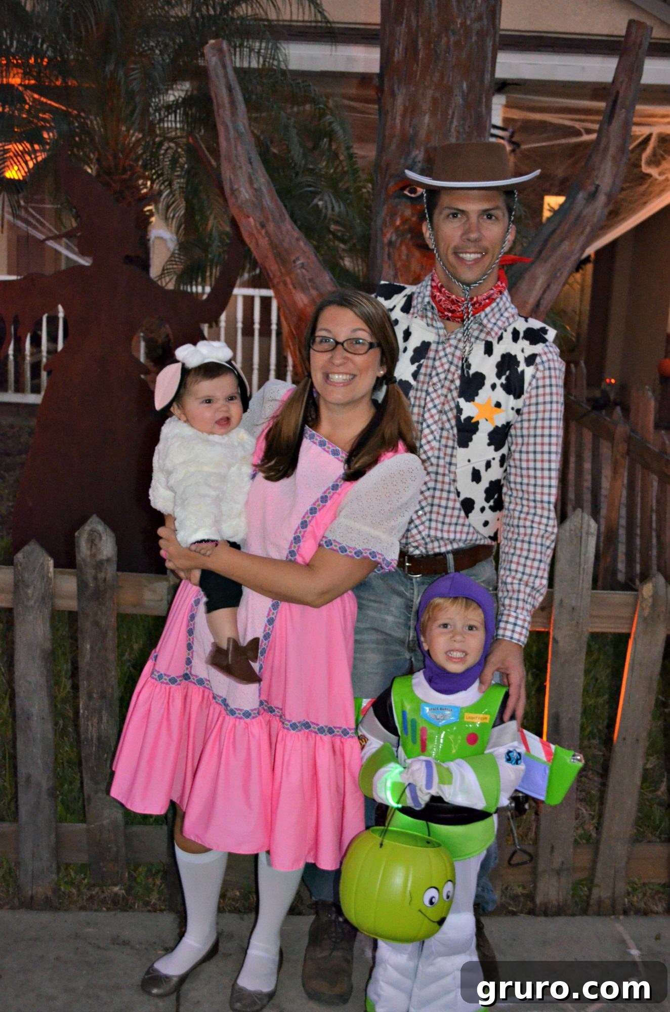 Family dressed in Toy Story costumes, with Buzz Lightyear holding the Alien Trick or Treat Bucket