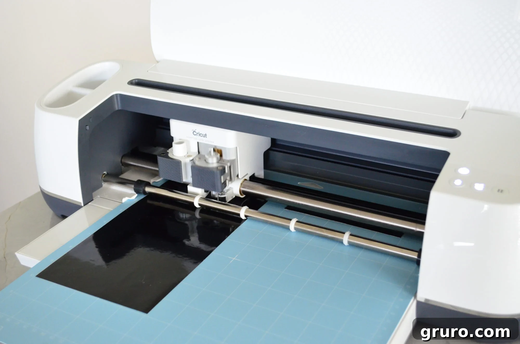 Cricut Maker cutting black vinyl for the Alien's features