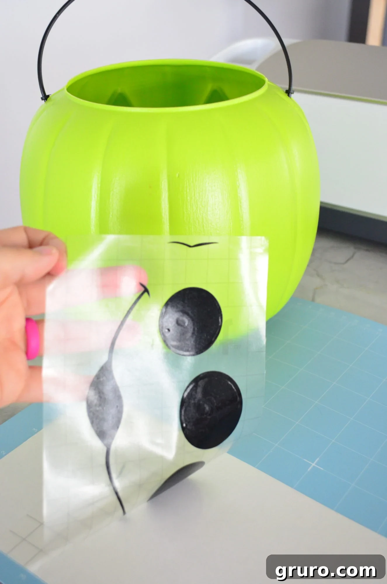 Carefully removing the transfer tape with the complete Alien vinyl design from its paper backing