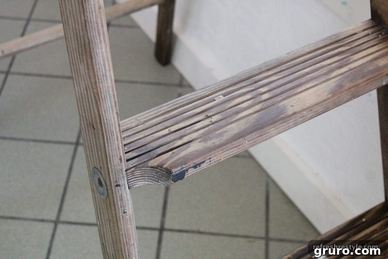Close-up of a vintage wooden ladder's characterful rungs
