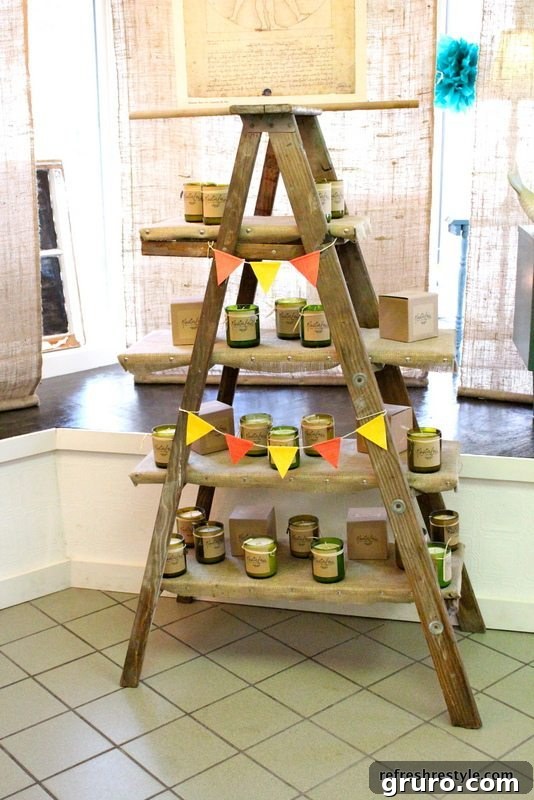 Finished DIY ladder shelf displaying soy candles and banners