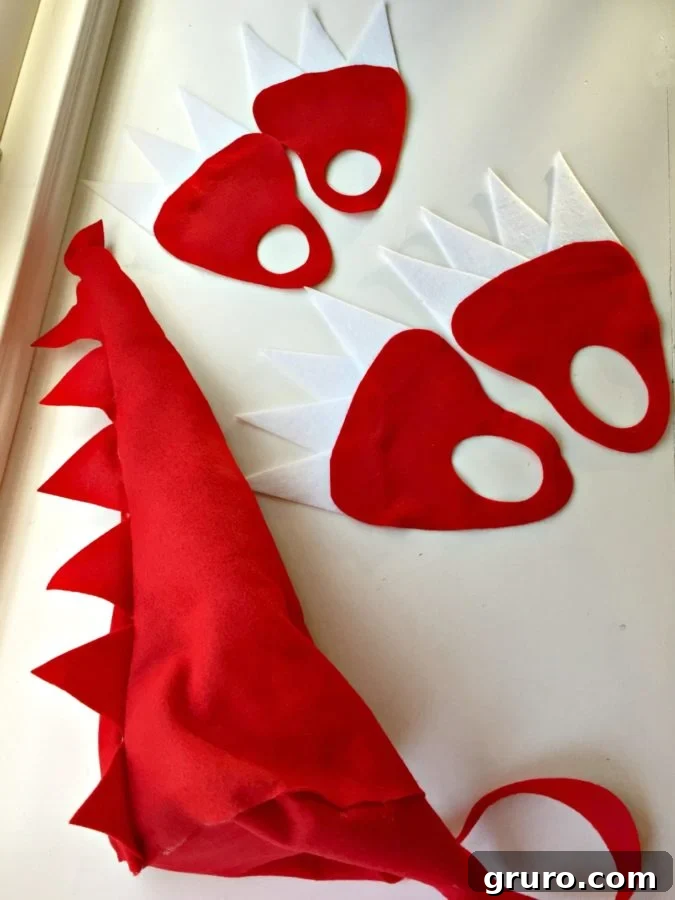 Dinosaur felt pieces including claws, hands, feet, and tail
