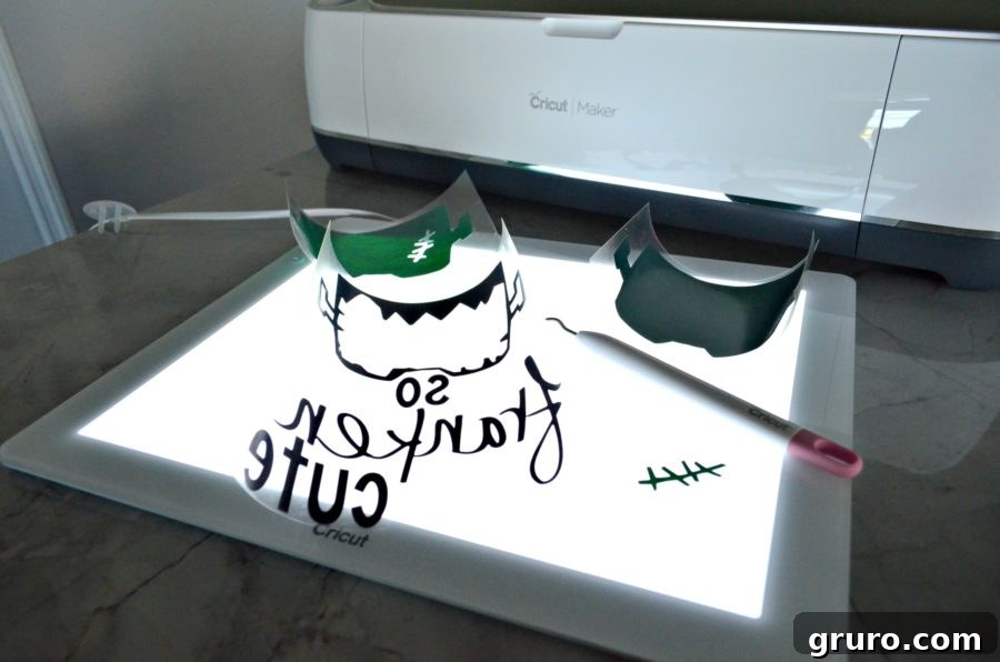 Cricut BrightPad illuminating the 'So Franken Cute' design for easy Iron-On Vinyl weeding