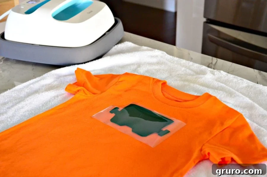 First layer of the 'So Franken Cute' dark green Frankenstein head design positioned on a t-shirt for pressing