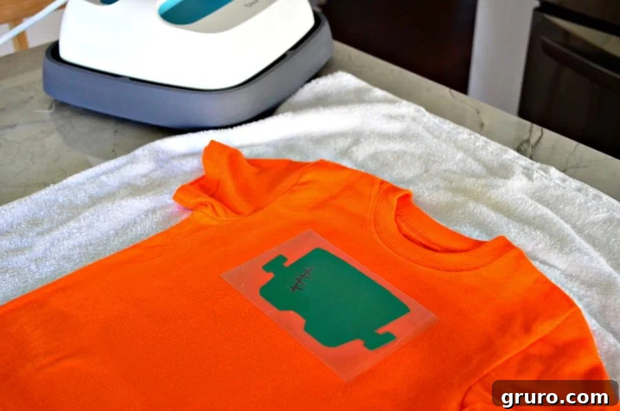Second layer of the 'So Franken Cute' bright green design precisely placed over the first dark green layer on the t-shirt