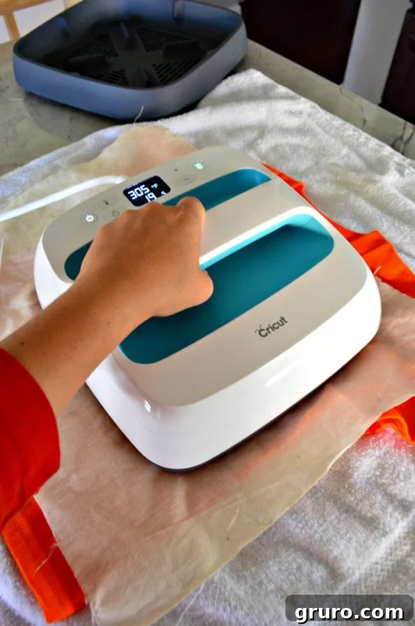 Cricut EasyPress applying heat to the 'So Franken Cute' Halloween t-shirt, ensuring perfect Iron-On Vinyl adhesion