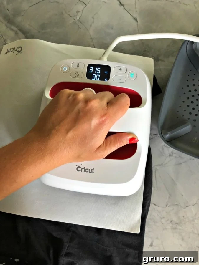 Cricut EasyPress applying spider web design to dress