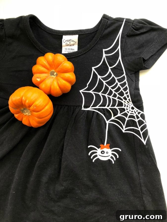 Toddler Girls DIY Spider Web Dress at park with pumpkins
