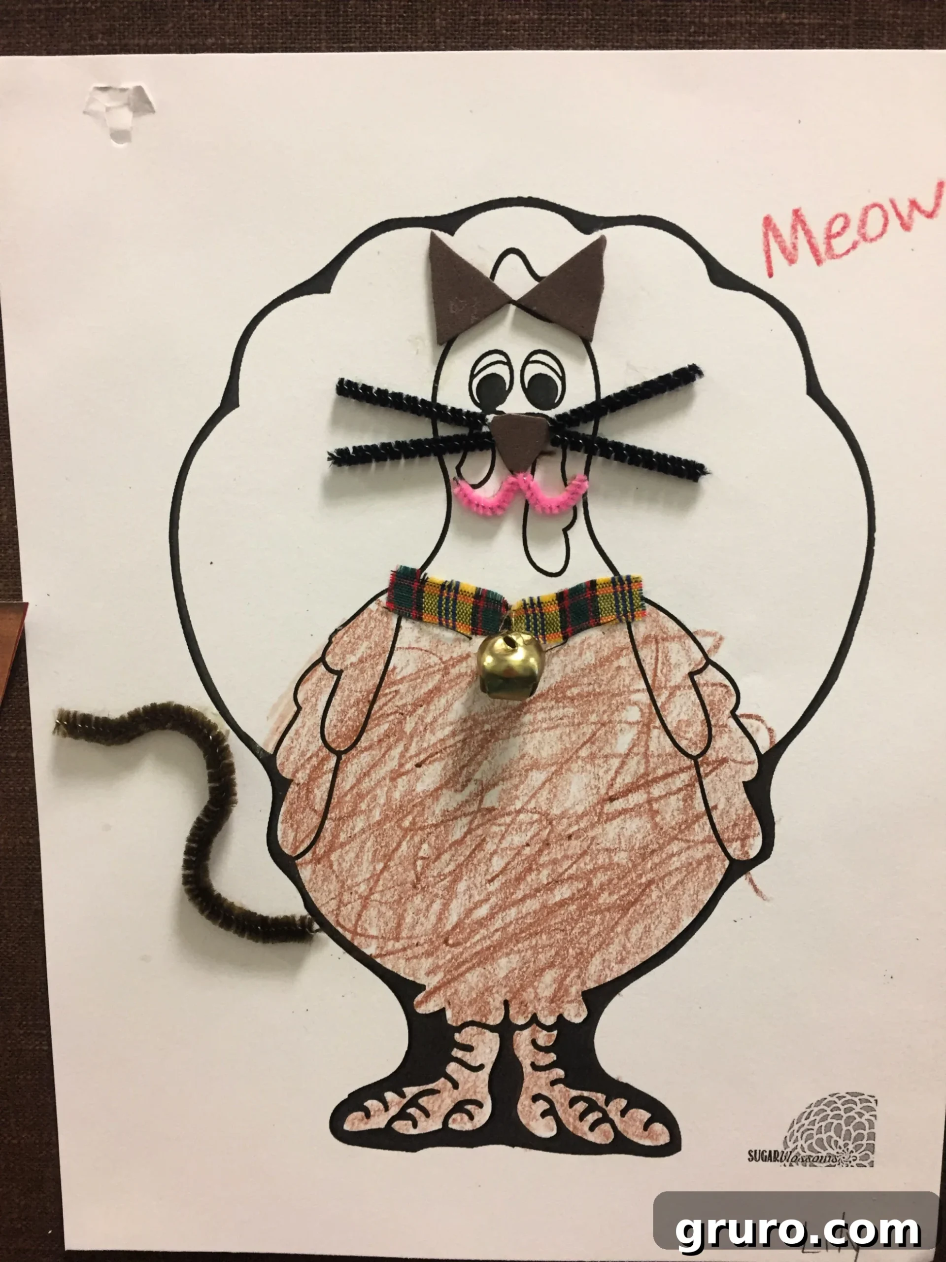 Paper Turkey In Disguise as a colored brown Kitty Cat with pipe cleaner whiskers, tail, and a cloth collar with real bell.