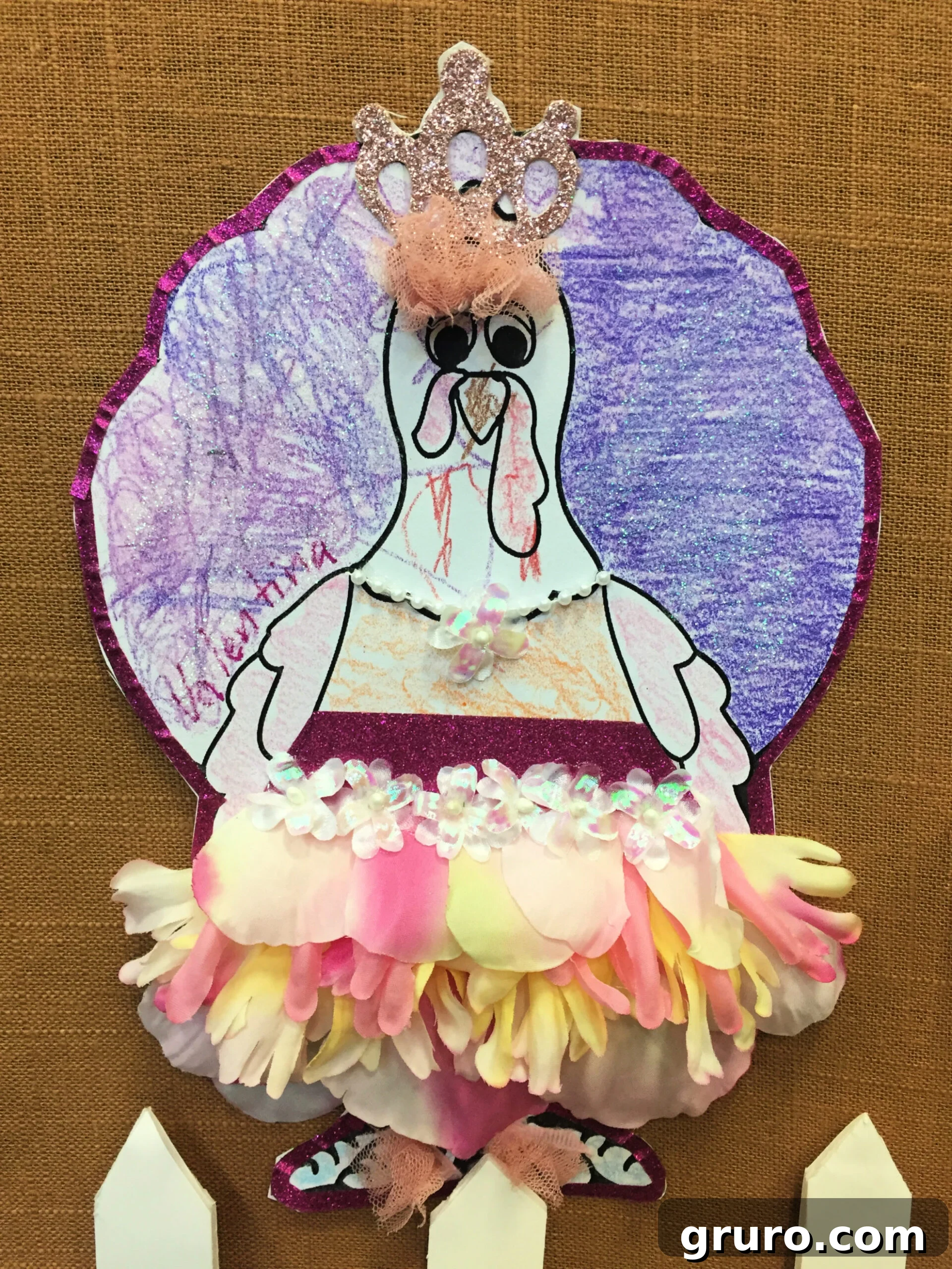 Paper Turkey In Disguise dressed as a Princess with flower petal tutu, purple top and glitter.