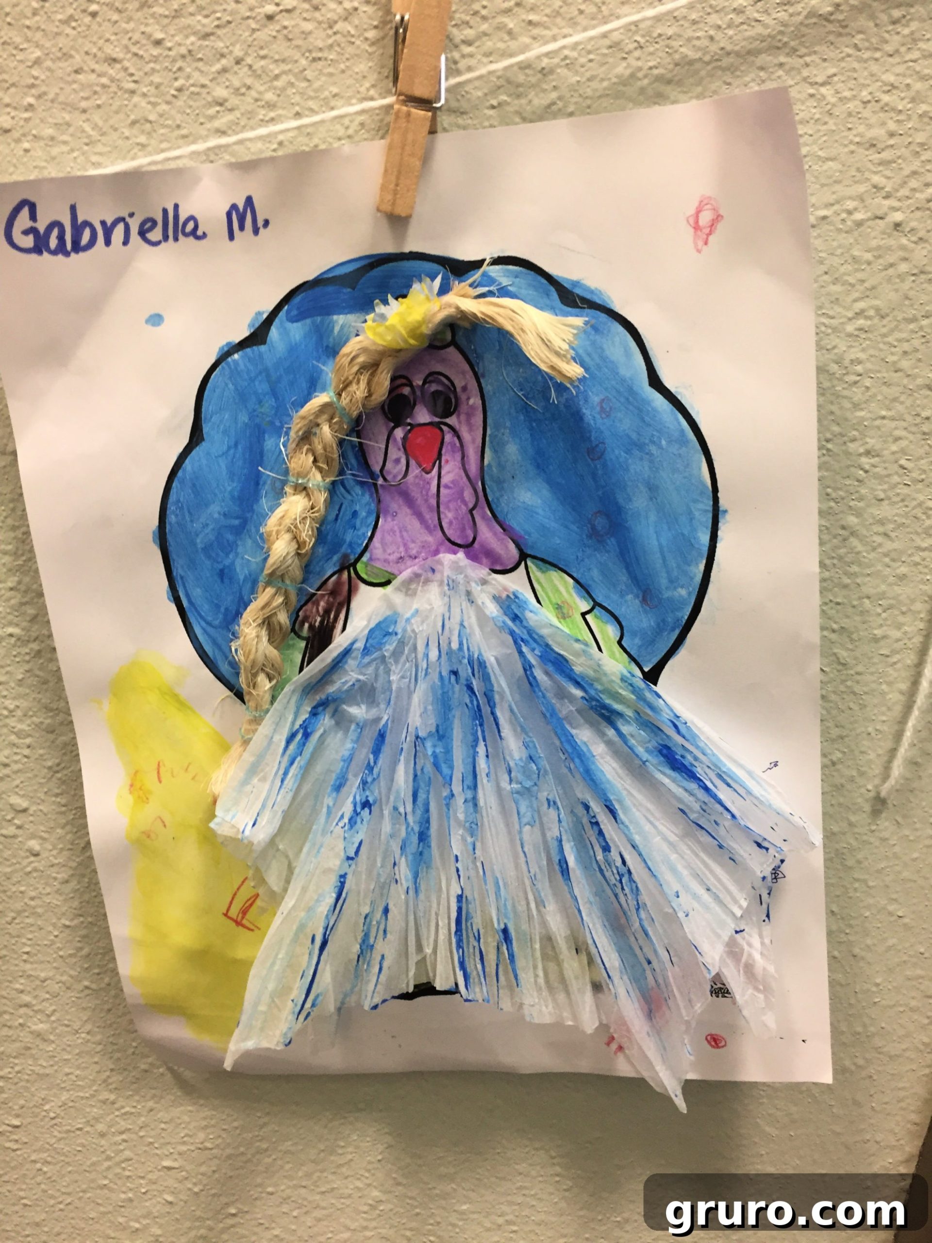 Paper Turkey In Disguise dressed as Elsa with a white and blue tissue paper dress, and a braided rope for hair.