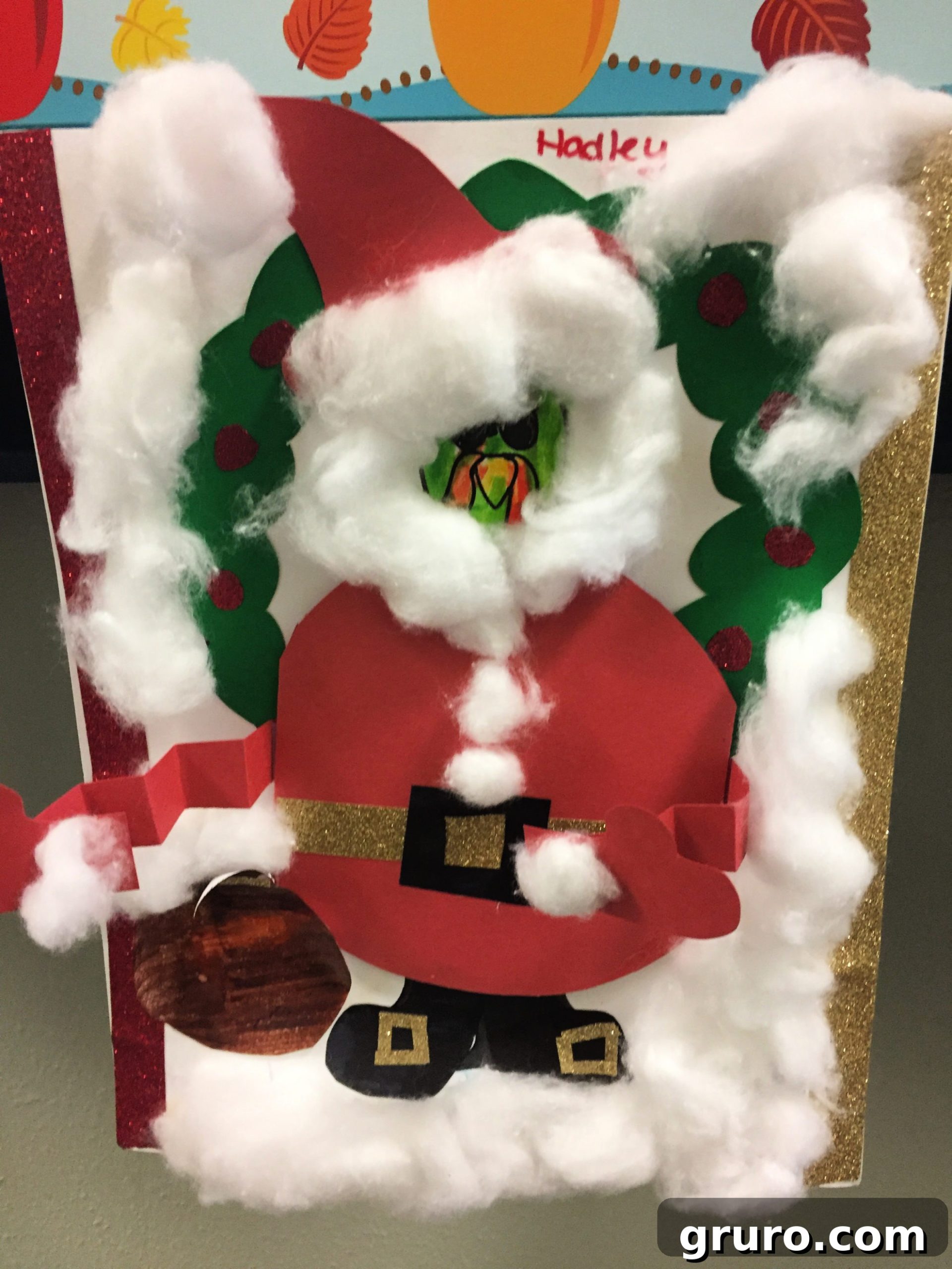 Paper Turkey In Disguise dressed as Santa Claus with red construction paper outfit with cotton balls around for snow and beard.