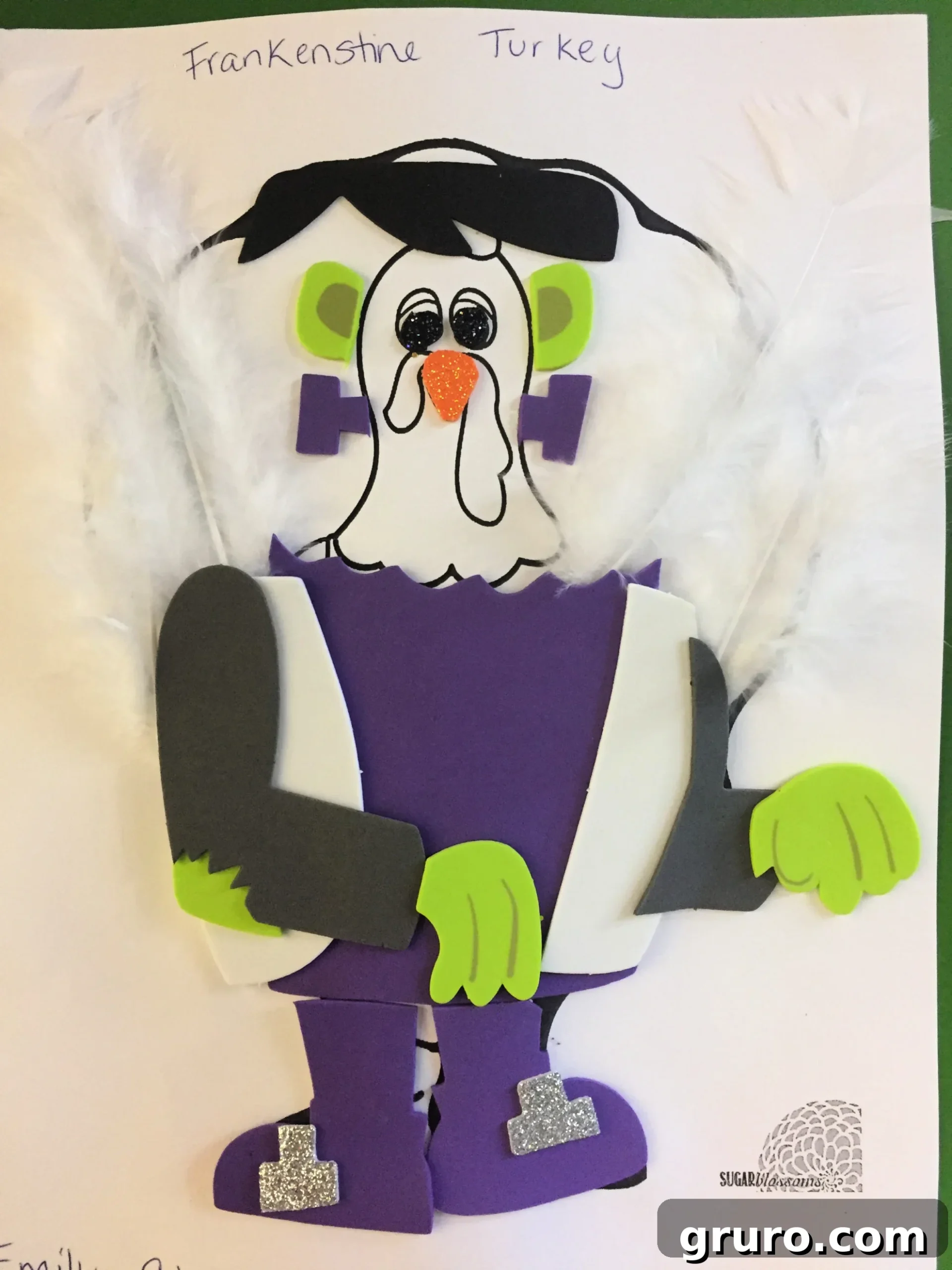 Paper Turkey In Disguise dressed as Frankenstein with foam clothing, and white feathers in the back. 