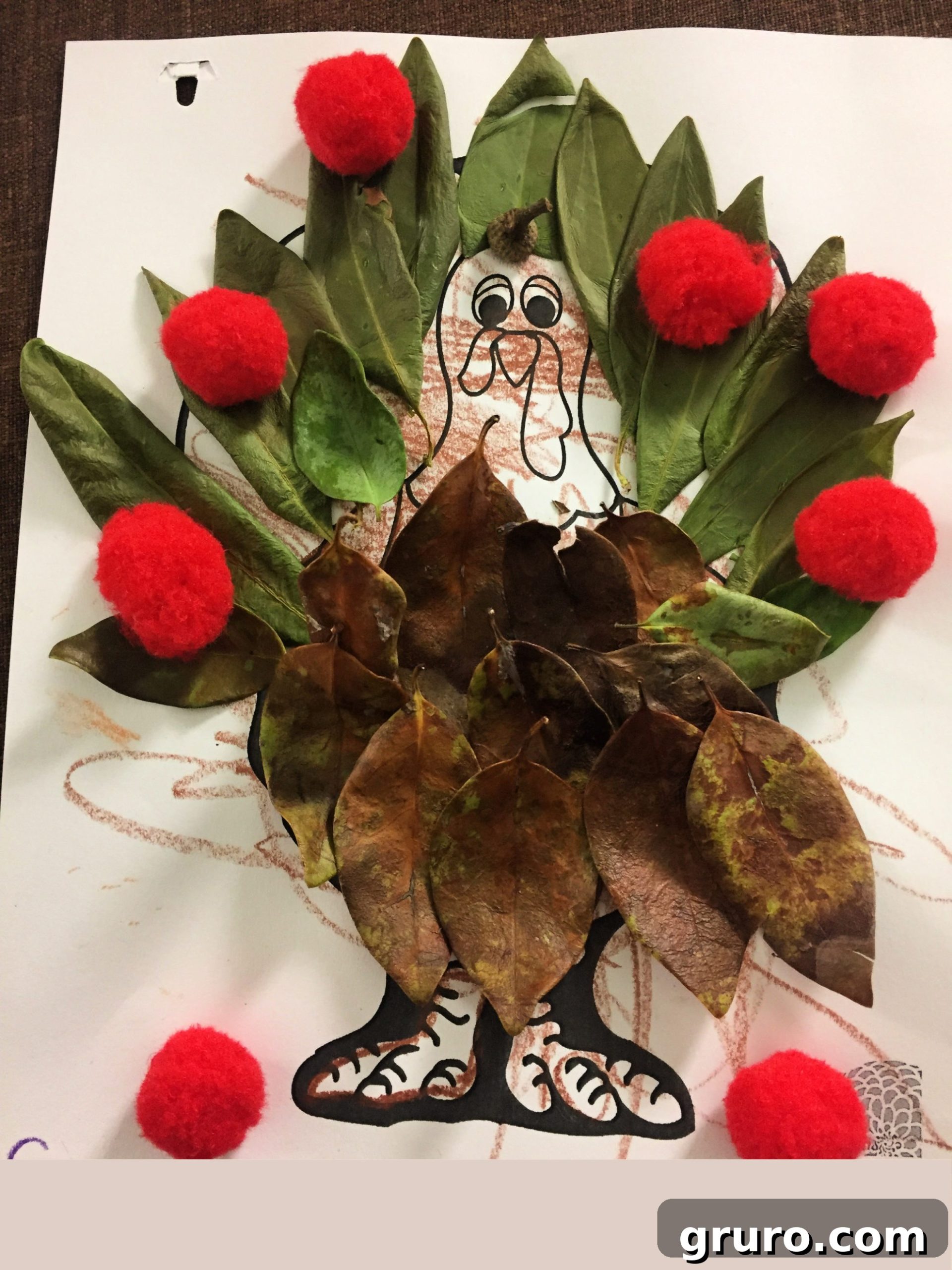 Paper Turkey In Disguise Camouflage with green and brown leaves and red pom poms.