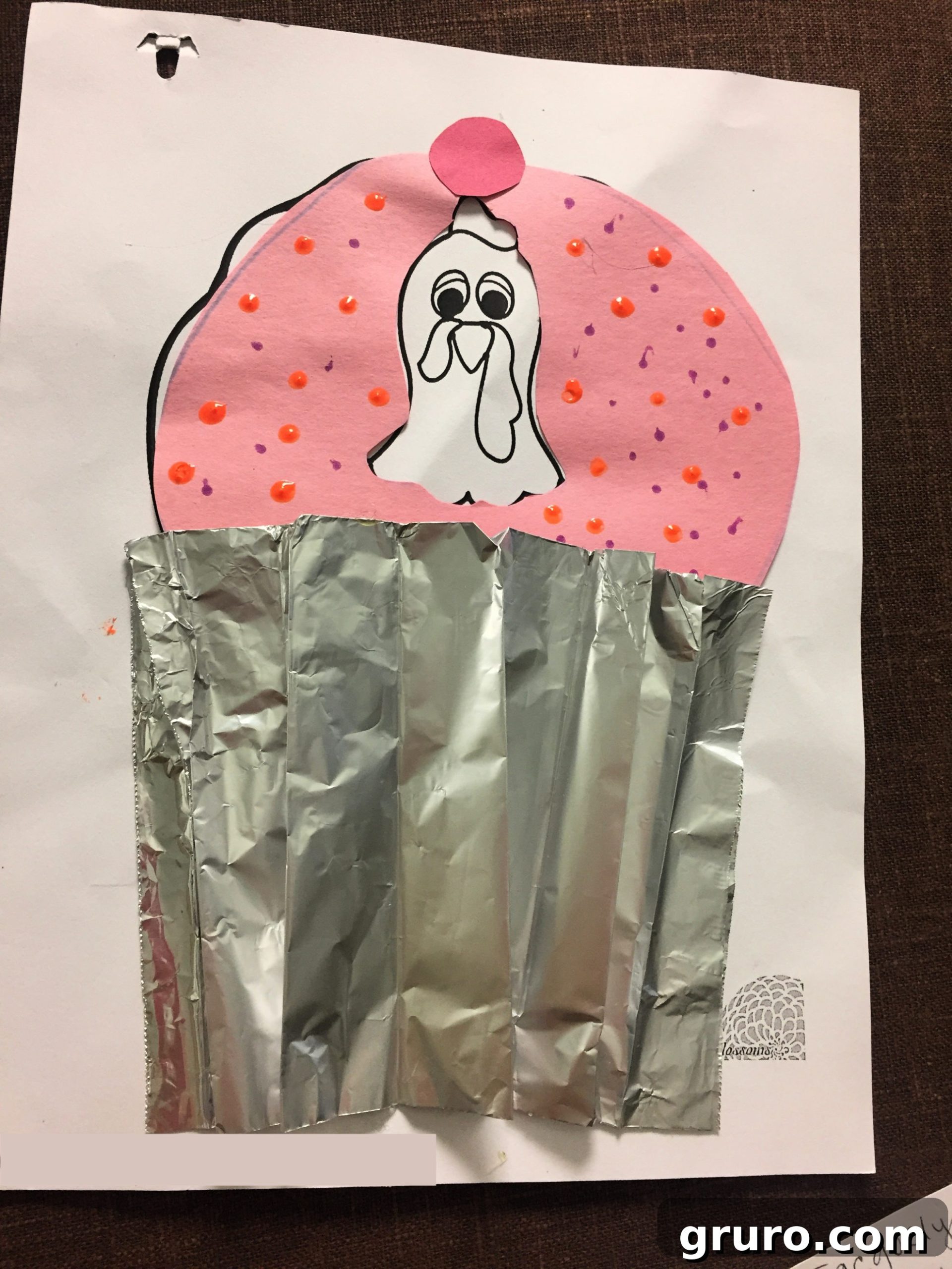Paper Turkey In Disguise dressed as a Cupcake with tinfoil wrapper and pink construction paper with little dots as sprinkles.