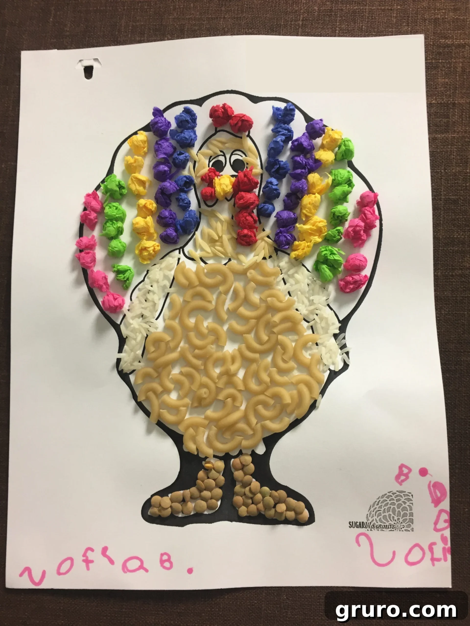 Paper Turkey In Disguise with macaroni noodles nad rice glued to it with little tissue paper balls made into a Rainbow.
