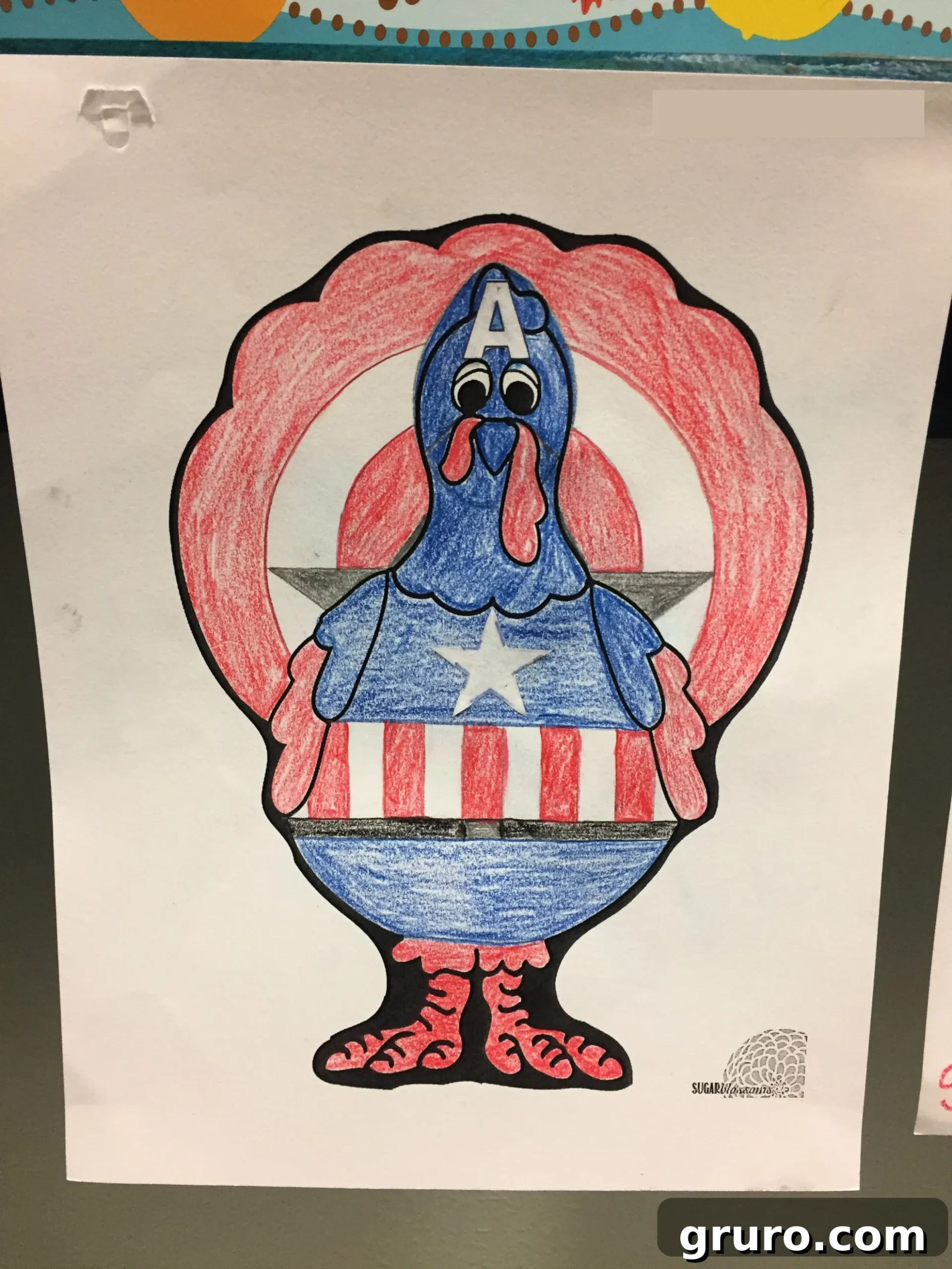Colored Turkey In Disguise as Captain America with red white and blue crayons.