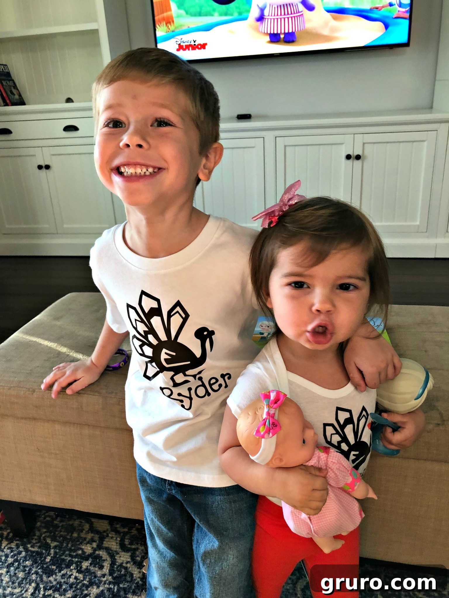 A brother and sister modeling their matching personalized Thanksgiving turkey shirts, showing off the festive designs for siblings.