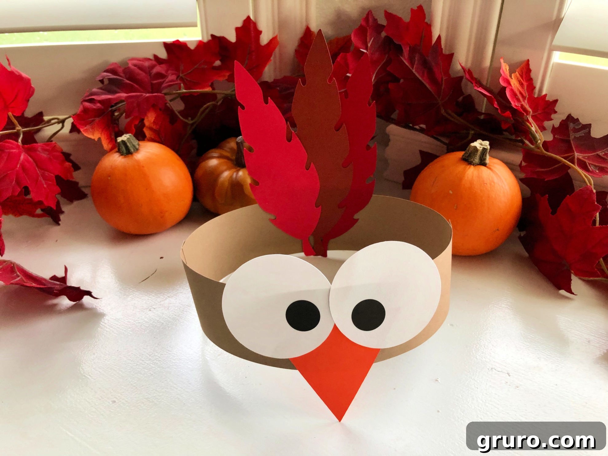 Turkey Paper Headband with fall leaves in the background.