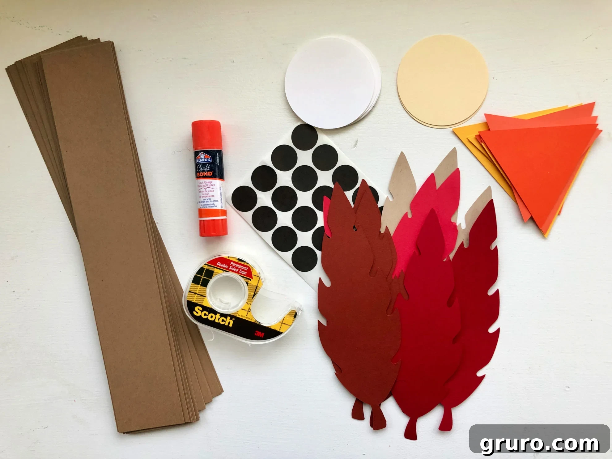 Supplies: brown card stock strips, paper feathers, orange paper beaks, tape, glue, black dots.