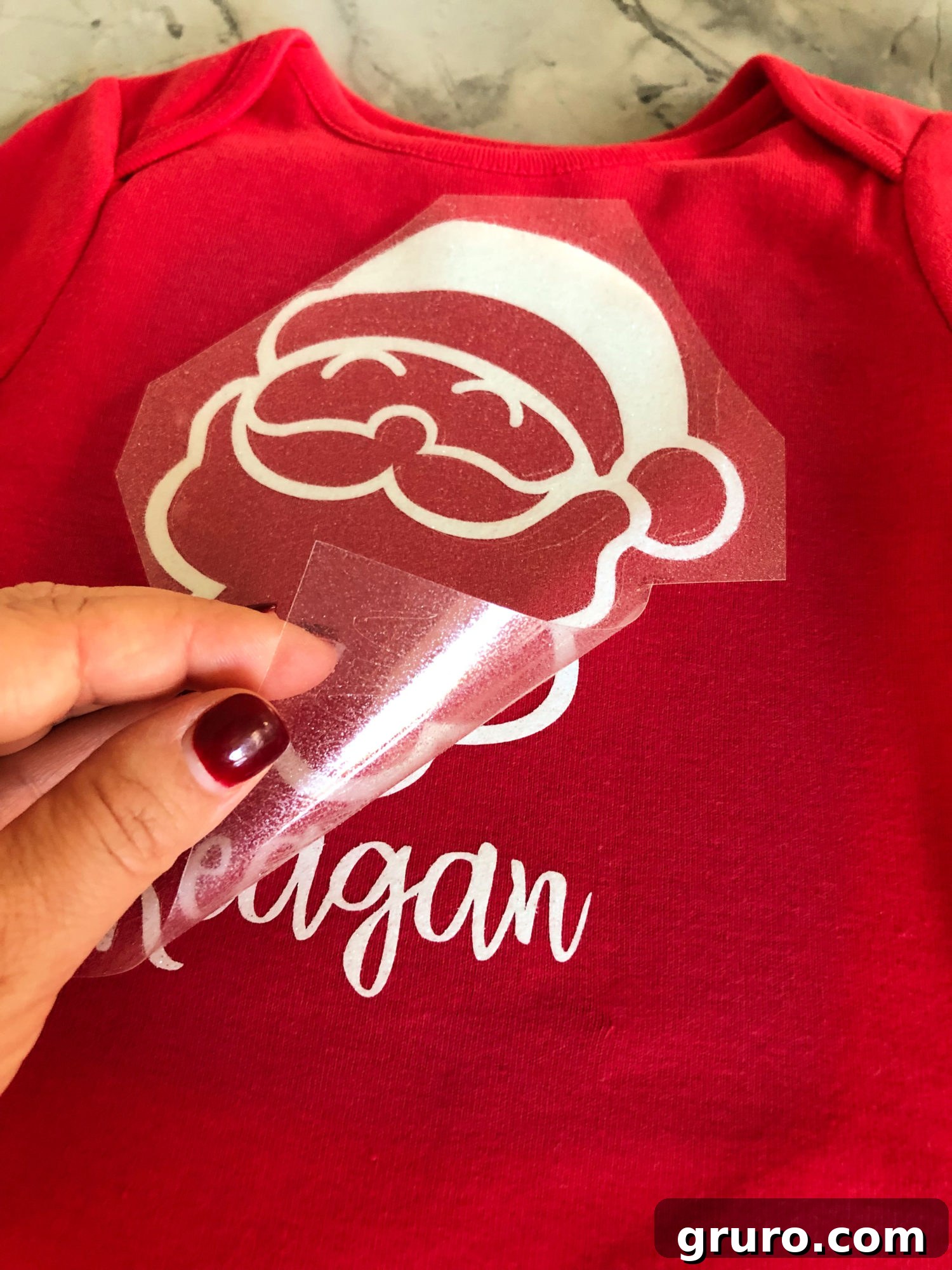 Peeling off plastic from personalized Santa T-shirt