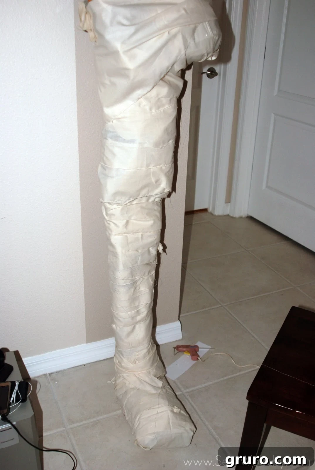 The mummy's body mostly covered in muslin, revealing the texture