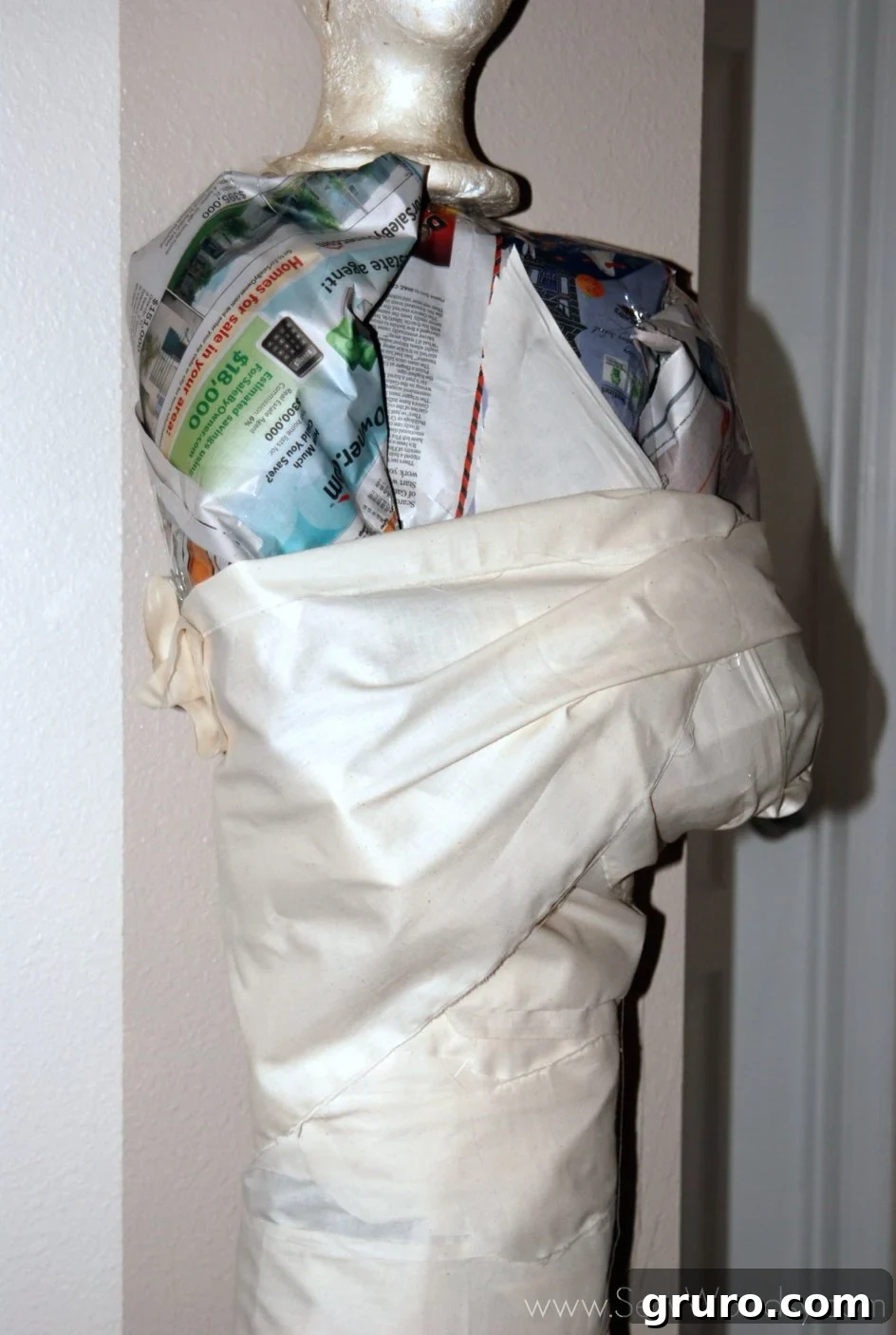Focus on the wrapped arms and torso of the mummy