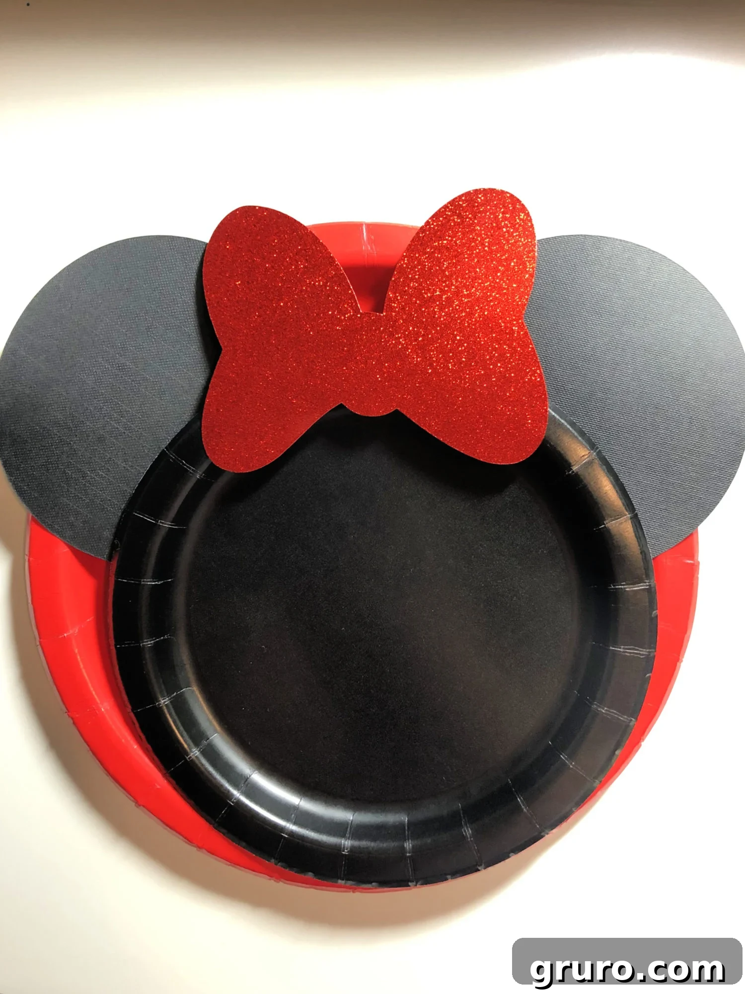 Finished DIY Minnie Mouse Paper Plates made with Cricut, perfect for birthday parties.