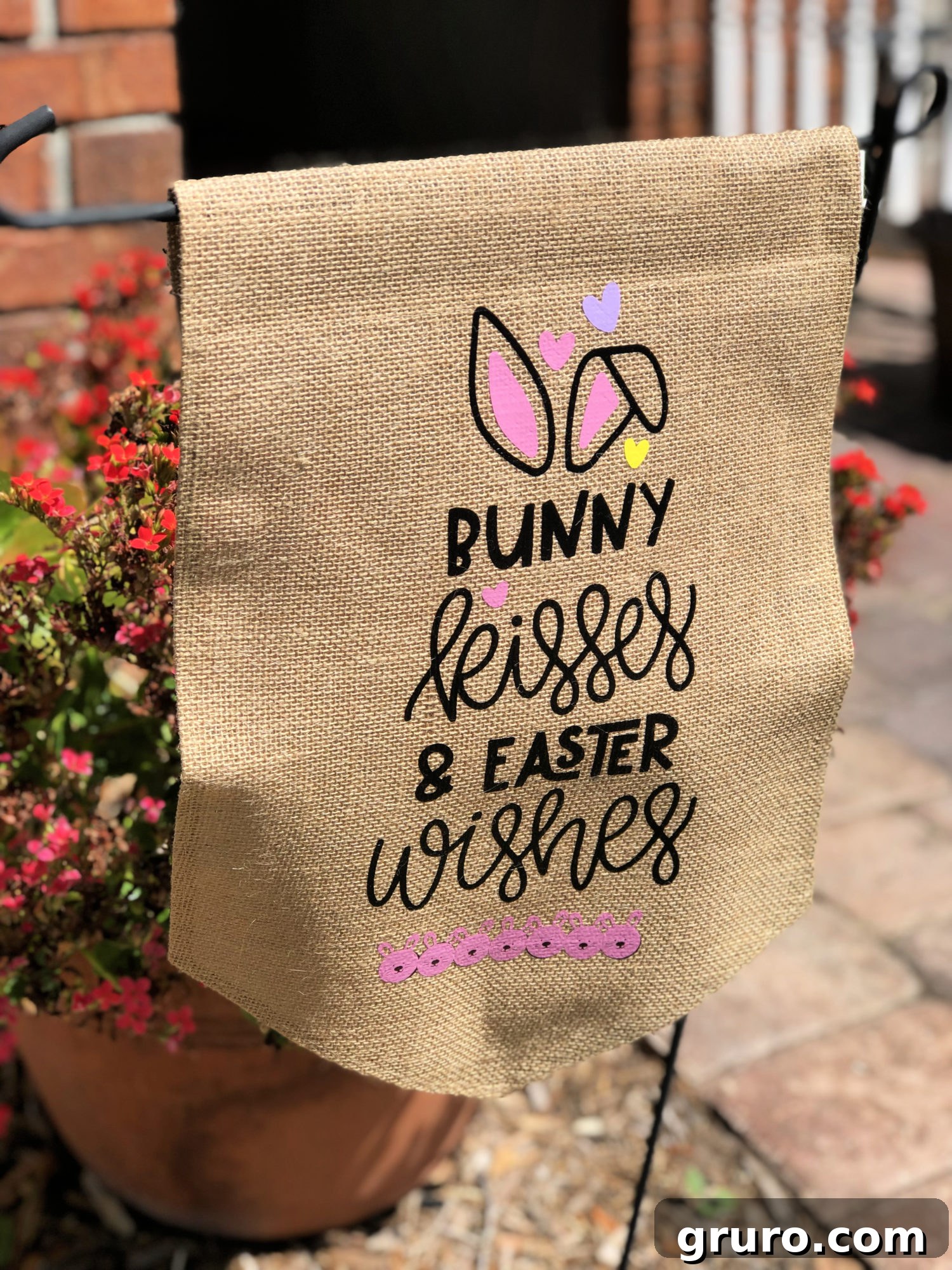 The completed Bunny Kisses & Easter Wishes DIY Burlap Garden Flag, ready to be displayed.