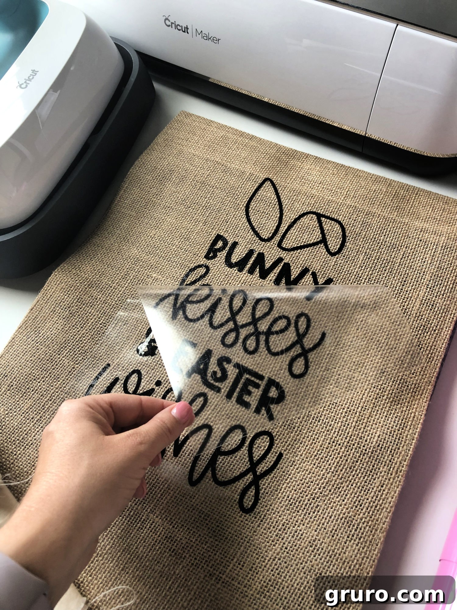 Warm peeling the carrier sheet from the Iron-On Vinyl on the Bunny Kisses & Easter Wishes Burlap Garden Flag.