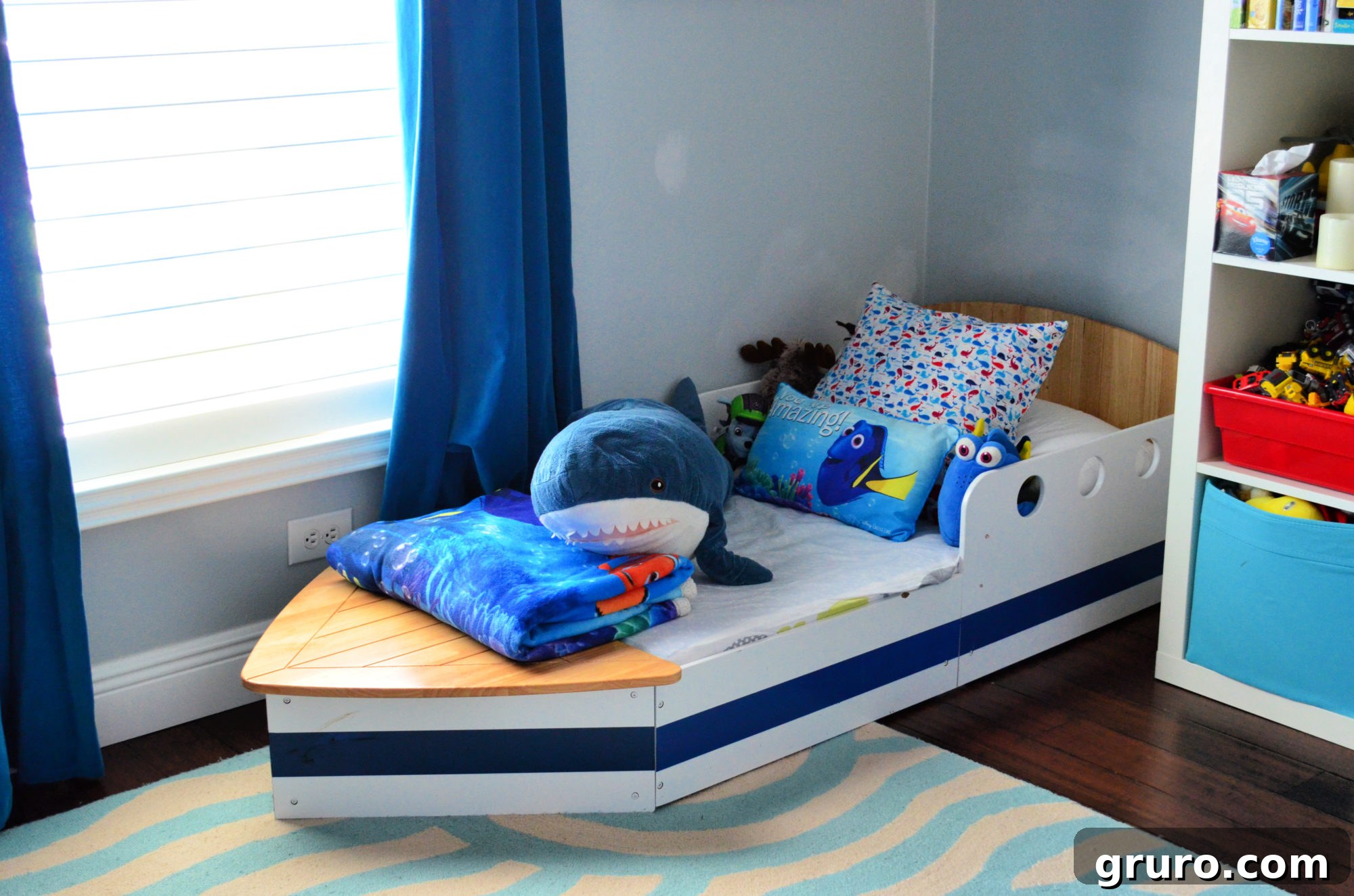 Kid's boat shaped toddler bed with nautical bedding