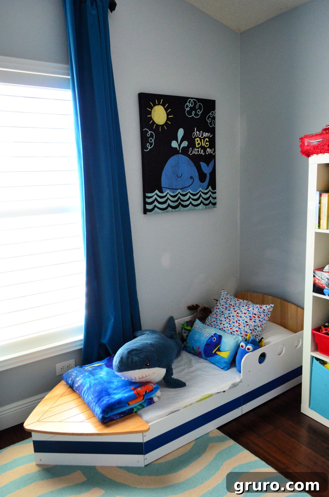 Nautical toddler room with boat bed and blackout curtains