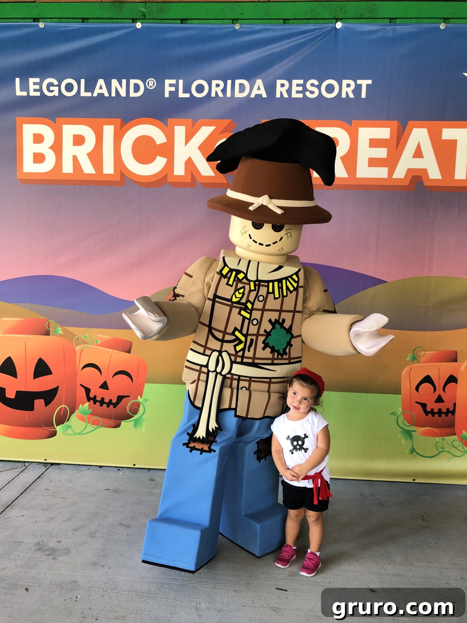 LEGO Scarecrow character at Brick or Treat with a child