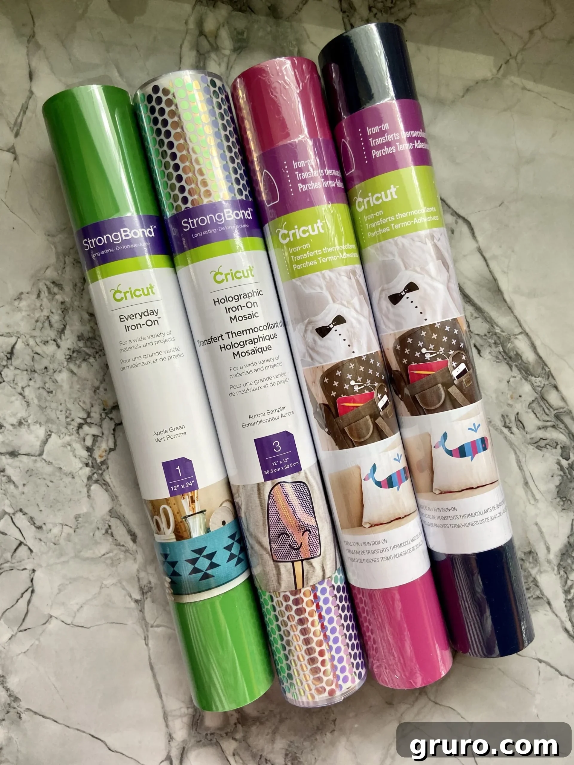 Four rolls of colorful Cricut Iron-On Vinyl in various patterns and solid colors.