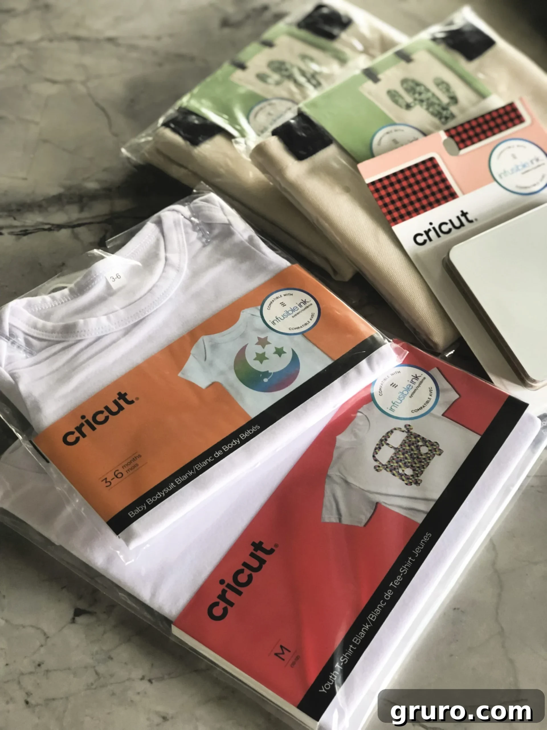 A display of Cricut Infusible Ink blanks, including tote bags and coasters, ready for sublimation projects.