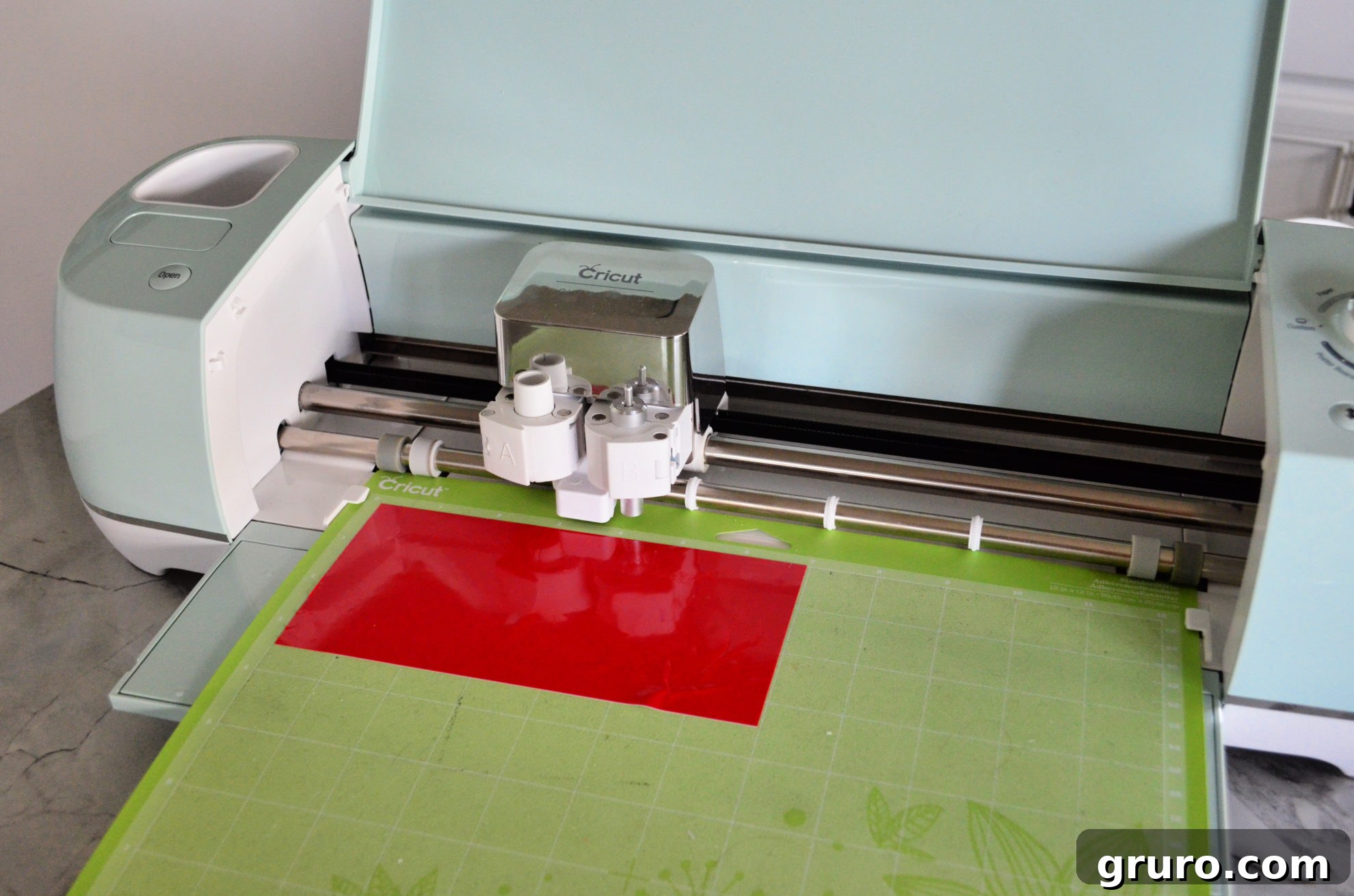 Cricut Explore Air 2 cutting red adhesive vinyl for Jingle Juice Glasses