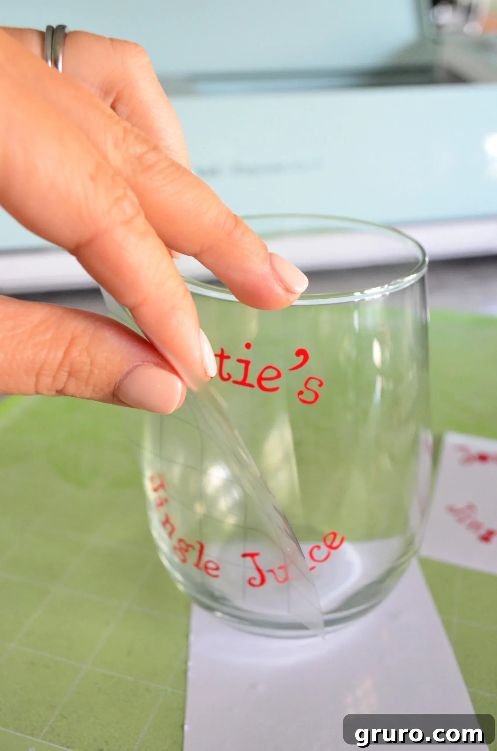 Applying personalized Jingle Juice vinyl to stemless wine glass