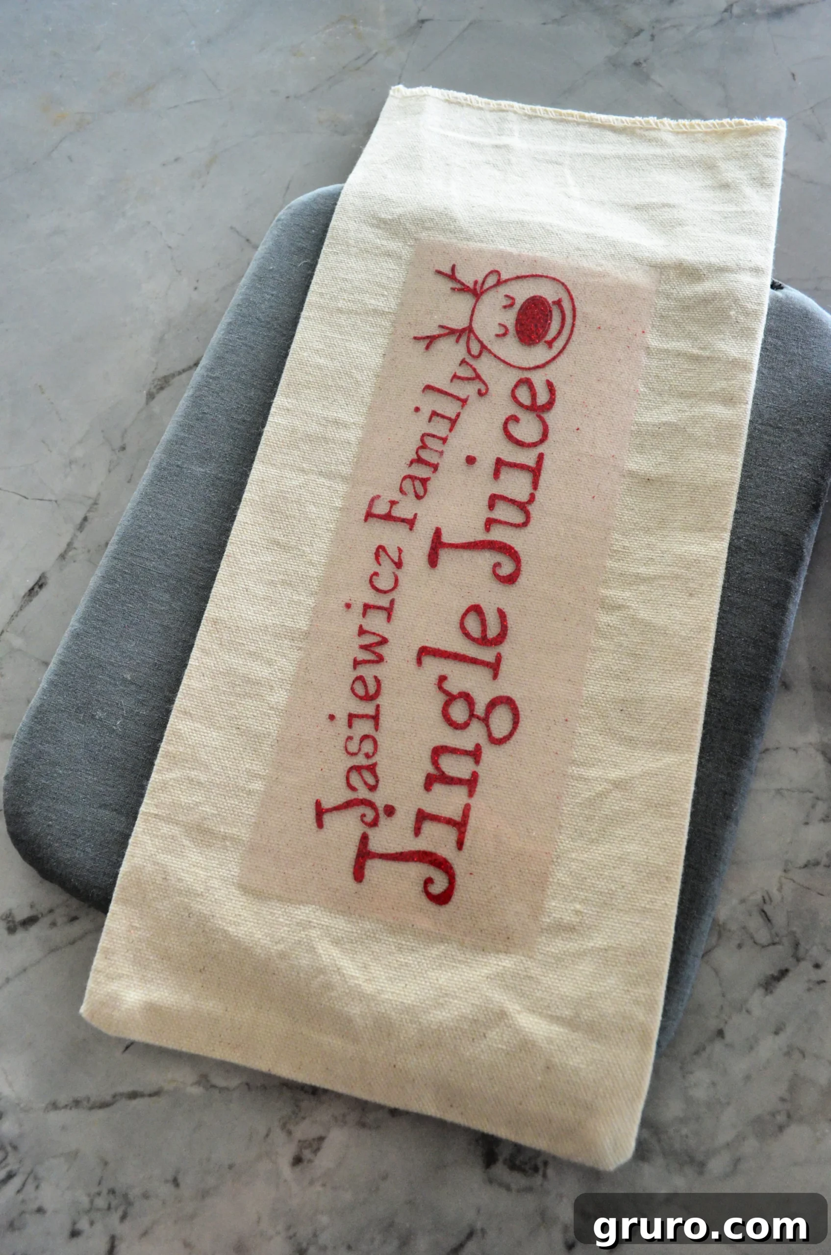 DIY Personalized Jingle Juice Wine Bag & Glasses with Cricut Iron-On Vinyl ready for application