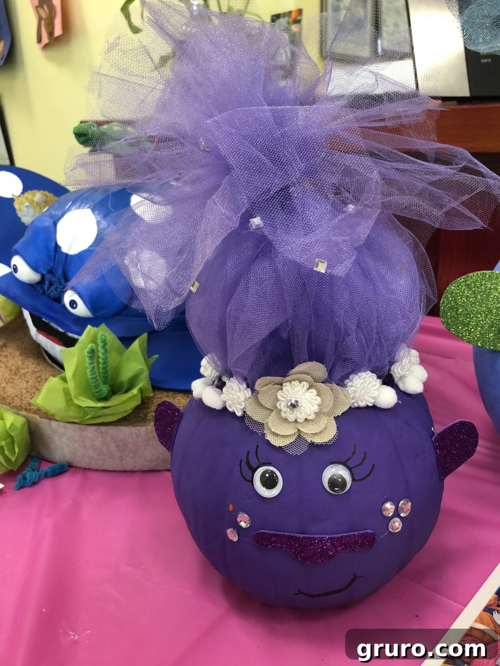 15 Creative No-Carve Pumpkin Decorations 16 A purple painted Troll pumpkin adorned with purple glitter foam and voluminous purple tulle hair.