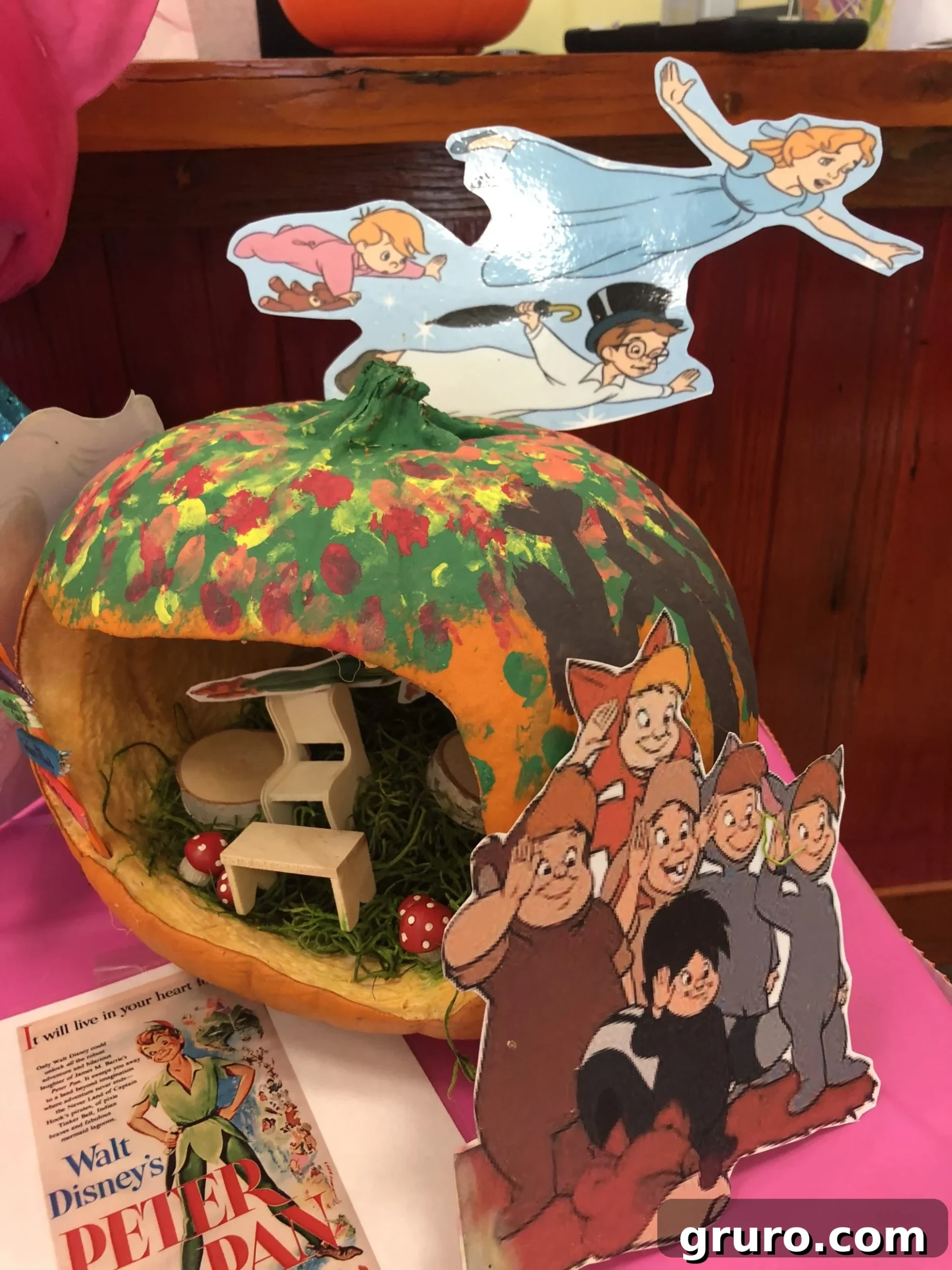 15 Creative No-Carve Pumpkin Decorations 6 A Peter Pan No-Carve Pumpkin featuring the iconic character and other Neverland misfit boys, creating a charming scene.